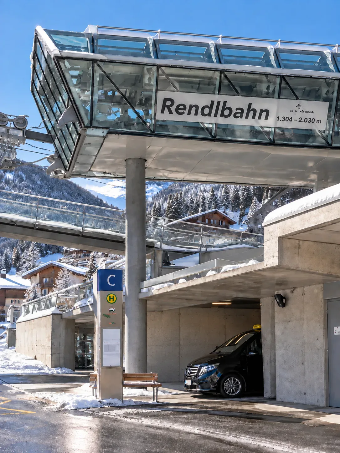 A taxi waiting in the underpass beneath the Rendlbahn valley station in St. Anton am Arlberg in winter